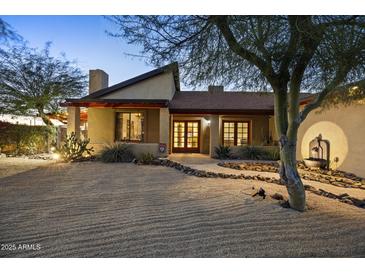 Charming single-story home featuring desert landscaping, stone accents, and a welcoming facade at 1422 E Royal Palm Rd, Phoenix, AZ 85020