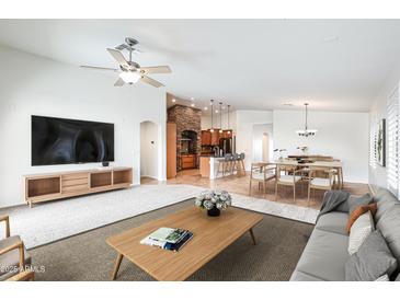 Spacious living room flows into the kitchen and dining area, creating a seamless entertaining space at 3005 W Donatello Dr, Phoenix, AZ 85086
