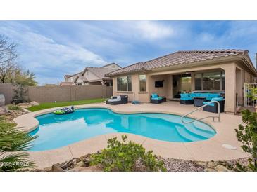 Inviting backyard pool with comfortable lounge furniture and covered patio, perfect for relaxing and entertaining outdoors at 42711 N 43Rd Dr, New River, AZ 85087