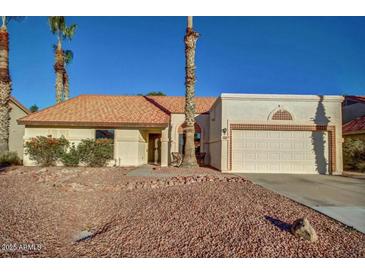 Charming single-story home featuring a tile roof and a two-car garage on a well-maintained lot at 5800 W Kesler St, Chandler, AZ 85226