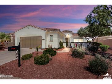 Charming home featuring a well-manicured yard and beautiful exterior architecture at 12860 W Junipero Dr, Sun City West, AZ 85375