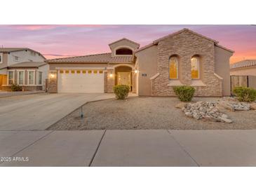 Charming single-Gathering home featuring a stucco and stone facade, a two-car garage, and neat desert landscaping at 22186 E Via Del Verde --, Queen Creek, AZ 85142