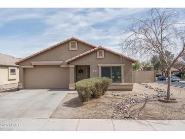 Charming single-Gathering home featuring a two-car garage and low-maintenance front yard landscaping at 2889 S 161St Dr, Goodyear, AZ 85338