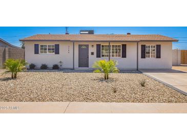 Charming single-story home featuring a desert landscape, covered entryway, and dark shuttered windows at 3249 E Nisbet Rd, Phoenix, AZ 85032