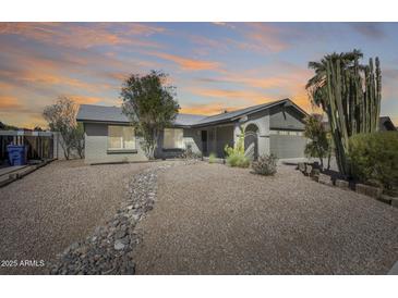Inviting home with well-kept landscaping, decorative rocks and a charming front entrance at 3325 N Desoto St, Chandler, AZ 85224