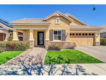 Charming single-story home with a well-manicured lawn, covered porch and a tandem 3-car garage at 4342 E Ronald St, Gilbert, AZ 85295