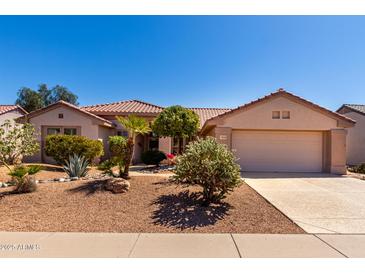 Charming single-story home with a well-manicured desert landscape and a two-car garage at 15936 W Clear Canyon Dr, Surprise, AZ 85374