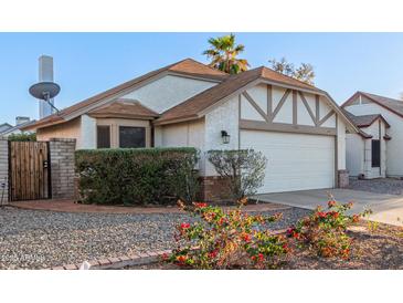 Charming single-story home featuring a two-car garage, landscaped yard, and inviting curb appeal at 1705 E Juanita Ave, Mesa, AZ 85204