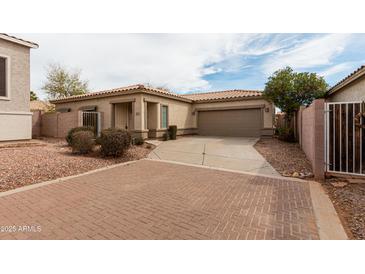 Charming single-story home featuring a two-car garage, brick driveway, and desert landscaping at 2624 E La Costa Dr, Chandler, AZ 85249