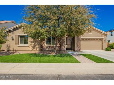 Charming home featuring well-maintained landscaping, a two-car garage, and a welcoming front entrance at 3046 E Athena Ave, Gilbert, AZ 85297