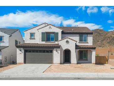 Charming two-story home with a tile roof, desert landscaping, and a two car garage at 6980 W Hedge Hog Pl, Peoria, AZ 85383