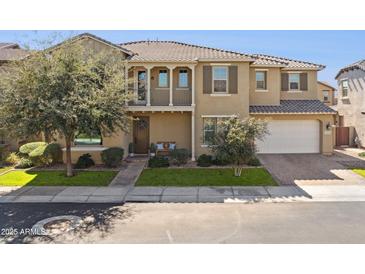 Charming two-story home featuring a balcony, well-manicured landscaping, and a welcoming front porch at 937 W Glacier Dr, Chandler, AZ 85248