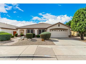 Charming single-story home with a well-manicured front yard, desert landscaping, and attached two-car garage at 9715 E Osage Ave, Mesa, AZ 85212