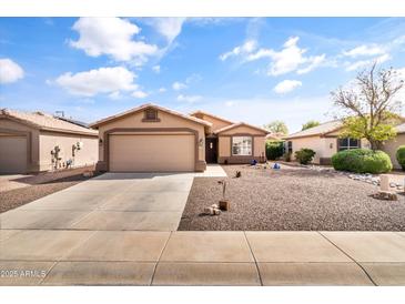 Charming single-Gathering home with a desert-landscaped front yard and two-car garage on a sunny day at 1475 E Runaway Bay Dr, Chandler, AZ 85249