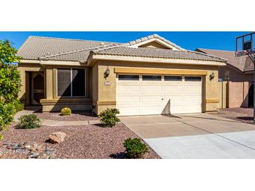 Charming single-story home with a two-car garage and low maintenance desert landscaping in front at 1552 E Shannon St, Chandler, AZ 85225