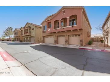 Attractive townhome with a 3-car garage, balcony, and desert landscaping at 2024 S Baldwin St # 161, Mesa, AZ 85209