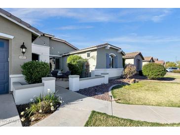 Charming single-story home featuring desert landscaping, covered patio and a beautiful walkway at 2483 E Narrowleaf Dr, Gilbert, AZ 85298