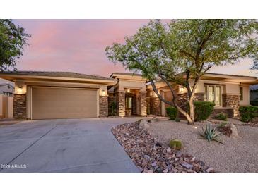 Charming home with stone accents, desert landscaping, and a three-car garage at 32215 N 16Th Ave, Phoenix, AZ 85085