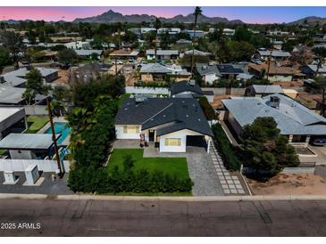 Charming single-Gathering home featuring a manicured lawn and a private backyard pool, offering a serene living environment at 3516 E Earll Dr, Phoenix, AZ 85018