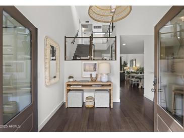 Charming foyer with views to the living and dining area features dark wood floors and modern finishes at 4446 E Camelback Rd # 104, Phoenix, AZ 85018