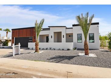 Beautiful desert-landscaped yard in front of a modern home with dark trim and minimalist features at 7325 E Virginia Ave, Scottsdale, AZ 85257
