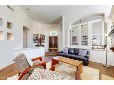 Bright living room with high ceilings, hardwood floors, and a view of the front entrance at 7705 E Doubletree Ranch Rd # 36, Scottsdale, AZ 85258