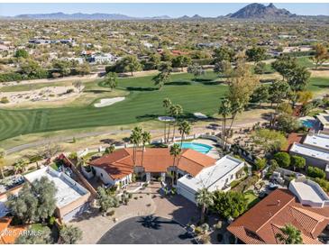 Stunning aerial view of a home with a pool overlooking the manicured golf course at 8262 E Vista De Valle --, Scottsdale, AZ 85255