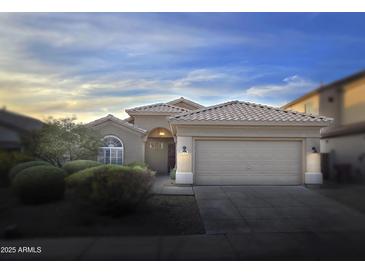Charming single-story home with a well-manicured front yard and a two-car garage at 10160 E Conieson Rd, Scottsdale, AZ 85260