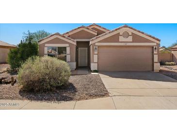 Charming single-story home with well-maintained landscaping and a two-car garage at 1137 W 21St Ave, Apache Junction, AZ 85120
