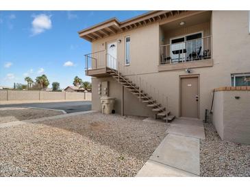 Exterior view of a two-story apartment building with private balconies, stairs, and desert landscaping at 17010 E Calle Del Oro -- # D, Fountain Hills, AZ 85268