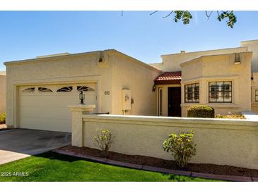 Charming single-story home featuring an attached garage, well-kept lawn, and inviting facade under a clear sky at 1839 E Vinedo Ln, Tempe, AZ 85284