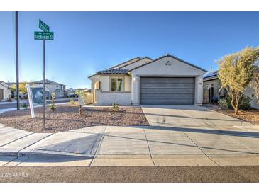 Charming single-story home featuring a two-car garage and low-maintenance desert landscaping at 20162 W Buchanan St, Buckeye, AZ 85326