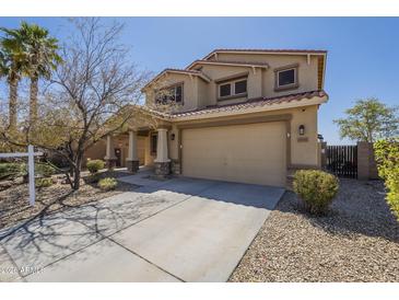Inviting two-story home showcasing a spacious driveway and well-manicured landscaping at 26842 N 176Th Ln, Surprise, AZ 85387