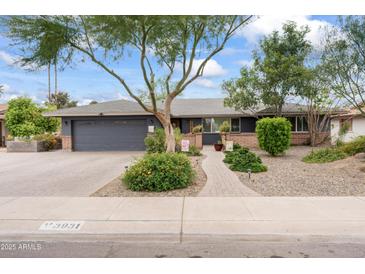 Charming single-story home with a manicured front yard, brick driveway, and cozy curb appeal in daytime at 3931 W Augusta Ave, Phoenix, AZ 85051