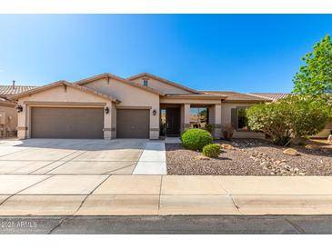Charming single-story home showcasing a well-maintained front yard and an attached two-car garage at 41961 W Centennial Rd, Maricopa, AZ 85138