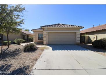 Charming single-story home featuring a two-car garage and a well-maintained xeriscaped front yard at 44583 W Windrose Dr, Maricopa, AZ 85138