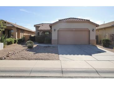 Charming single-story home featuring a well-maintained yard and two-car garage at 45071 W Yucca Ln, Maricopa, AZ 85139