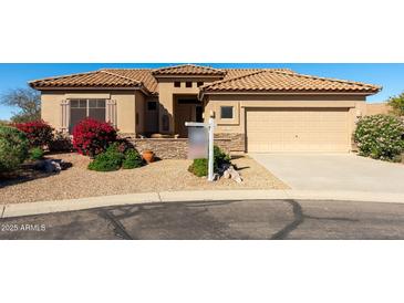 Charming single-story home with a tile roof and well-manicured desert landscaping for a warm and inviting curb appeal at 5812 S Staghorn Cholla Ct, Gold Canyon, AZ 85118