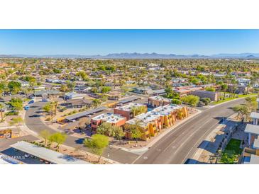 A lovely aerial view of the property and neighborhood, highlighting covered parking and mountain views in the distance at 604 E Weber Dr # 12, Tempe, AZ 85288