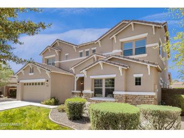 Inviting two-story home featuring a neutral color palette, well-maintained landscaping, and an attached two-car garage at 6204 S Banning St, Gilbert, AZ 85298
