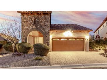 Beautiful home exterior featuring a stone tower and desert landscaping at 8542 E Indigo St, Mesa, AZ 85207