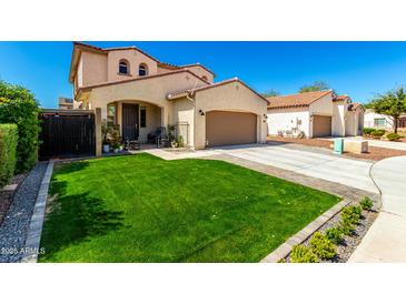 Beautiful two-story home boasting a lush green lawn and a welcoming front entrance at 10043 W Foothill Dr, Peoria, AZ 85383
