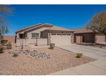 Charming single-story home featuring a tile roof, desert landscaping, and two-car garage at 1374 E Linda Dr, Casa Grande, AZ 85122