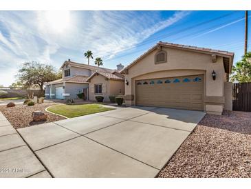 Charming single-Gathering home featuring a two-car garage and a well-maintained lawn with desert landscaping at 1569 E Princeton Ave, Gilbert, AZ 85234