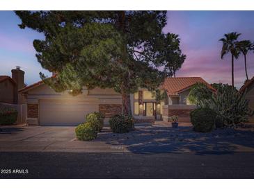 Charming single-story home featuring a two-car garage, stone accents, tile roof, and mature desert landscaping at 17246 N 56Th Way, Scottsdale, AZ 85254