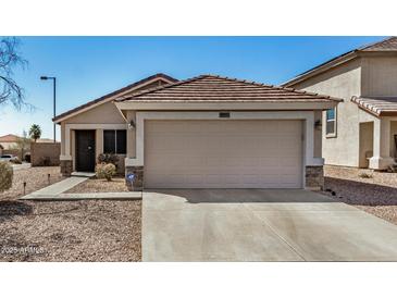 Charming single-story home with a well-manicured front yard and a two-car garage at 21941 W Solano Dr, Buckeye, AZ 85326