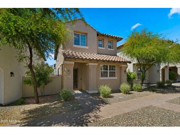 Charming two-story home with a tile roof, a covered porch and landscaped front yard at 29031 N 125Th Ln, Peoria, AZ 85383