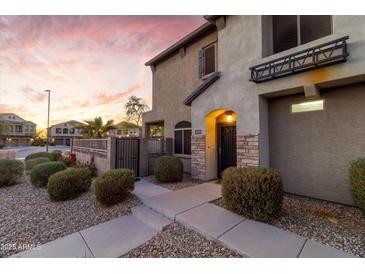Beautiful two-story home featuring stone accents, a well-manicured front yard, and inviting walkway at 470 N 168Th Ln, Goodyear, AZ 85338
