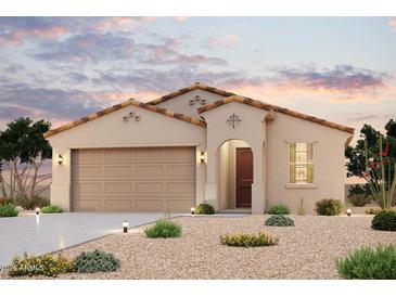 Charming single-story home with a two-car garage, stucco siding, and tile roof at 1935 S 246Th Ln, Buckeye, AZ 85326