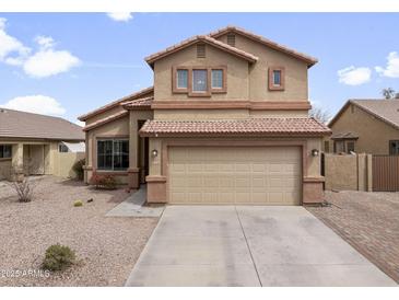 Charming two-story home featuring a spacious three-car garage and a well-maintained desert landscape at 22336 E Via Del Palo --, Queen Creek, AZ 85142